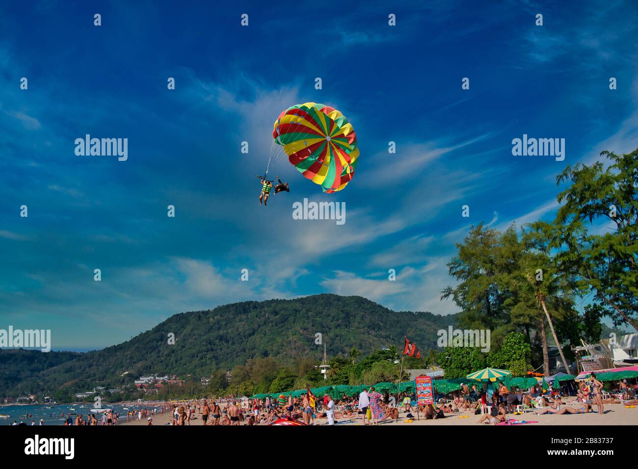 Flying on a parachute behind a boat on a summer holiday by the sea at