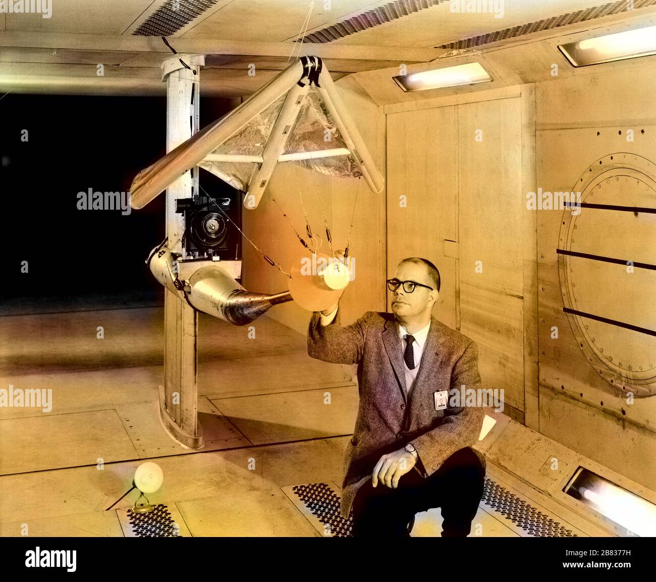 WC Sleeman, Jr inspecting a model of the 'Rogallo Wing' paraglider in wind tunnel at Langley Research Center, Hampton, Virginia, February 5, 1962. Image courtesy National Aeronautics and Space Administration (NASA). Note: Image has been digitally colorized using a modern process. Colors may not be period-accurate. () Stock Photo