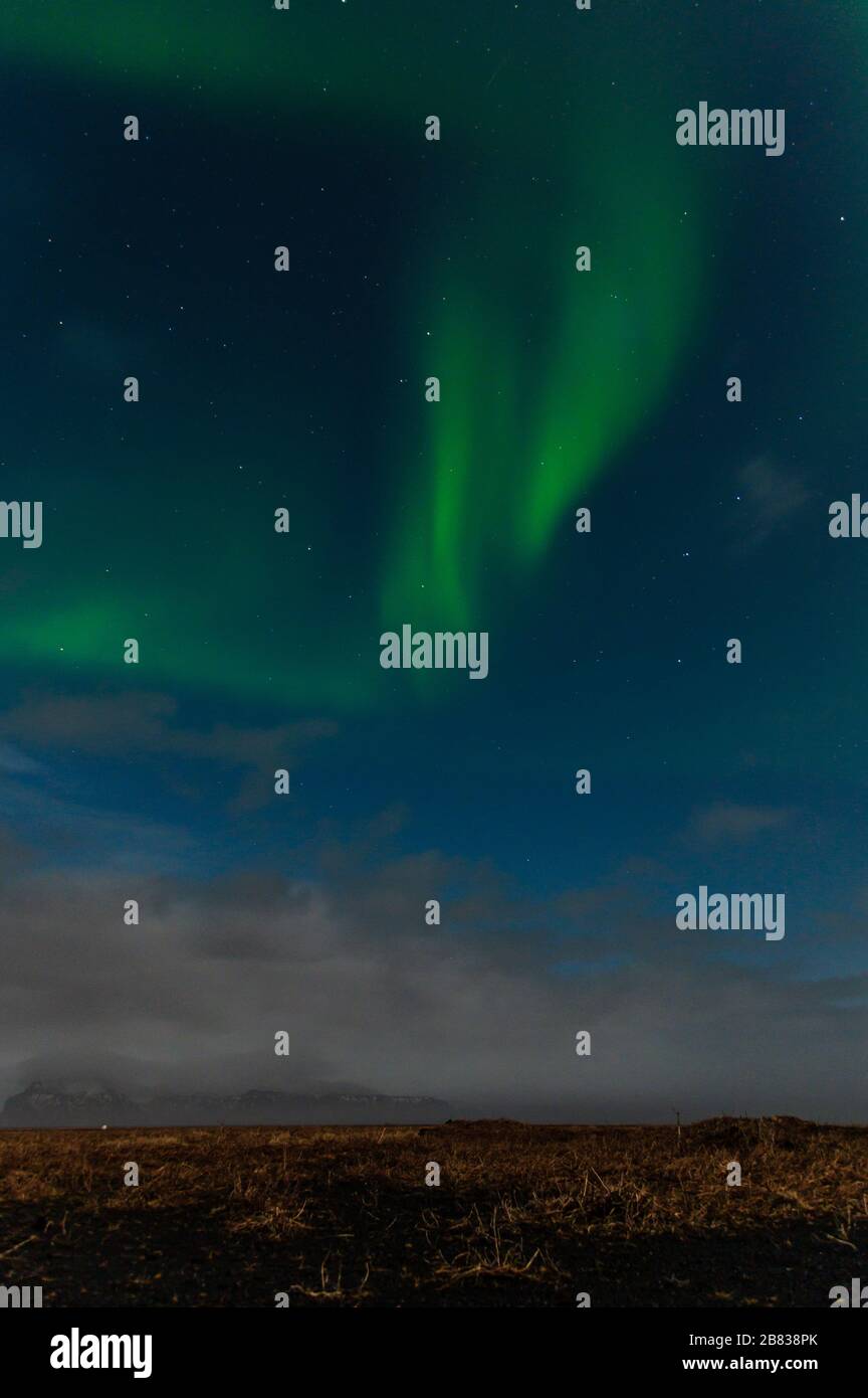 Aurora Borealis makes its appearance outside of Vik, Iceland. Stock Photo