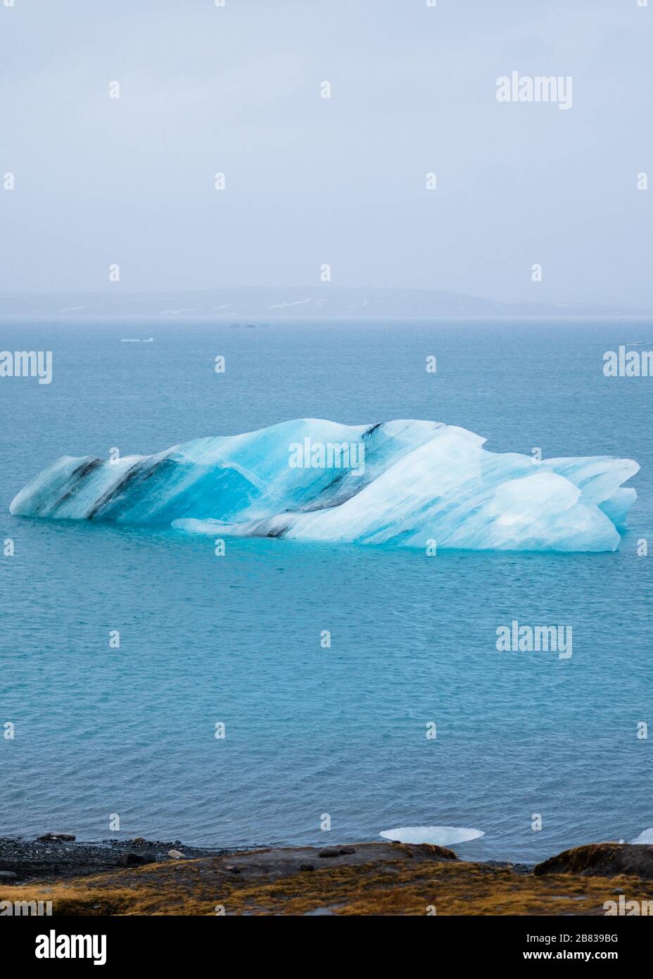 Iceberg floating in Jökulsárlón lagoon in winter time. Stock Photo