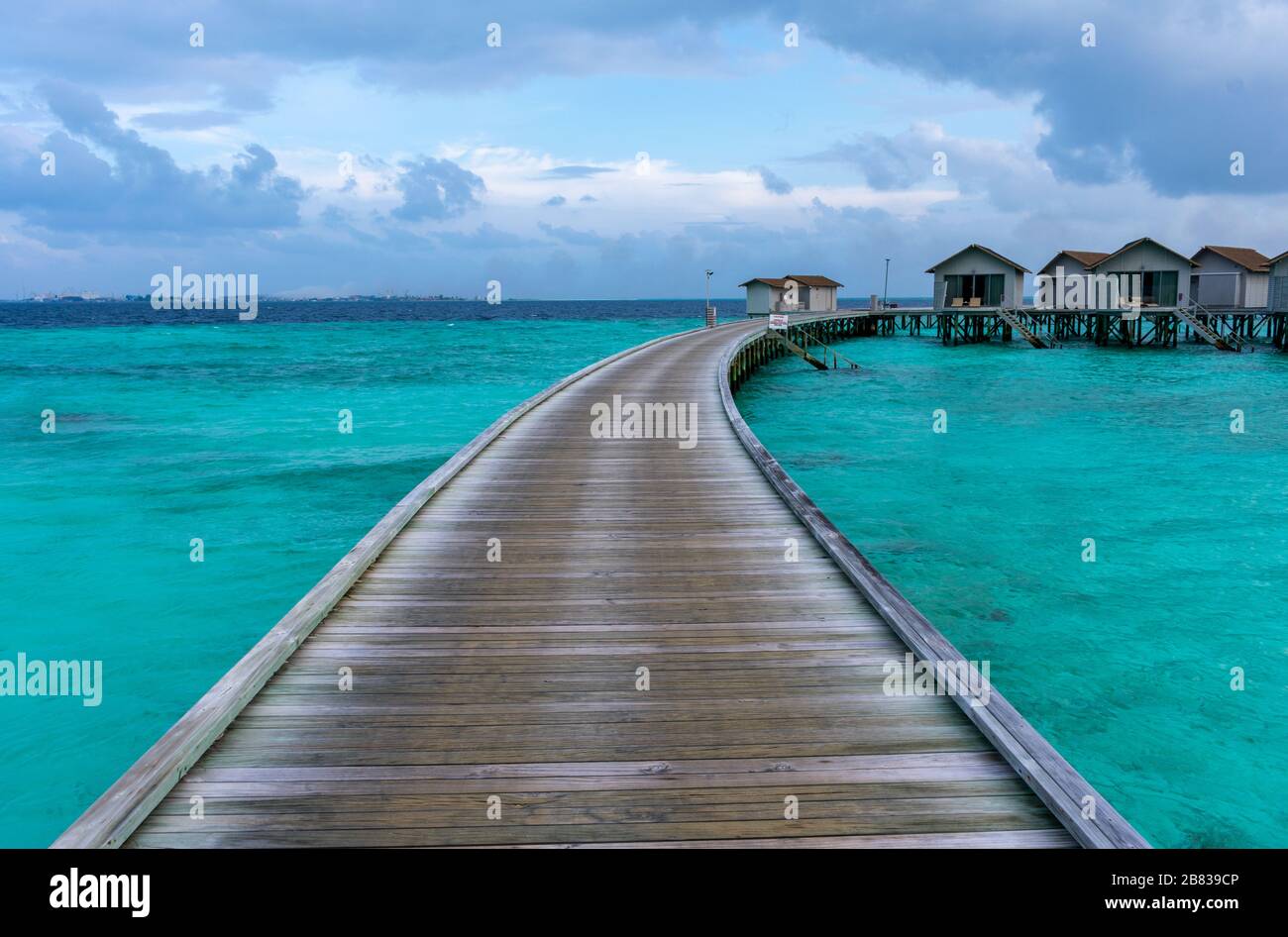 North Malé Atoll, Maldives - December 29 2019 - A wooden pier towards the water villas Stock Photo