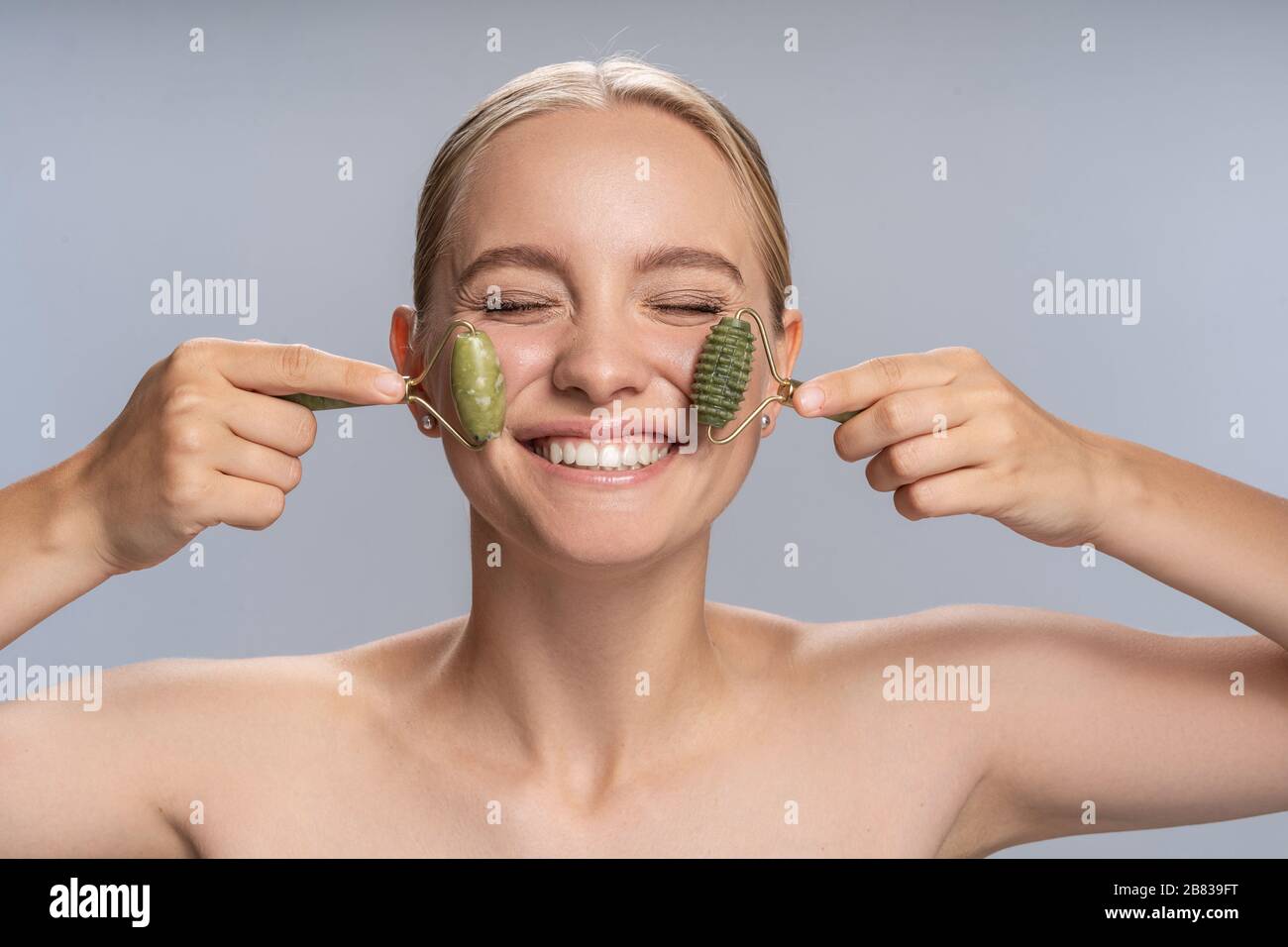 Cheerful girl taking care of her skin Stock Photo - Alamy