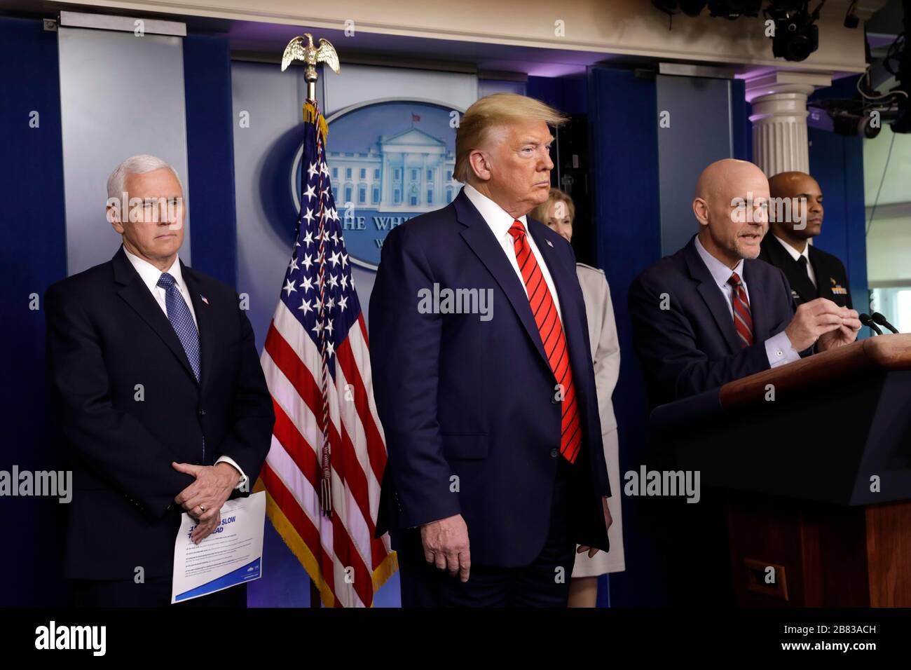 Washington DC, USA. 19th Mar, 2020. United States President Donald J. Trump, center, and US Vice President Mike Pence, left, listen to Stephen Hahn, Commissioner, US Food and Drug Administration (FDA), center right, speaking during a press briefing on the Coronavirus COVID-19 pandemic with members of the Coronavirus Task Force at the White House in Washington on March 19, 2020. At right is US Surgeon General Vice Admiral (VADM) Jerome M. Adams, M.D., M.P.H. Credit: MediaPunch Inc/Alamy Live News Stock Photo