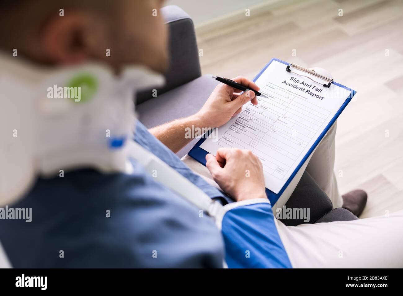Closeup Of A Businessperson With Broken Arm Filling Health Insurance