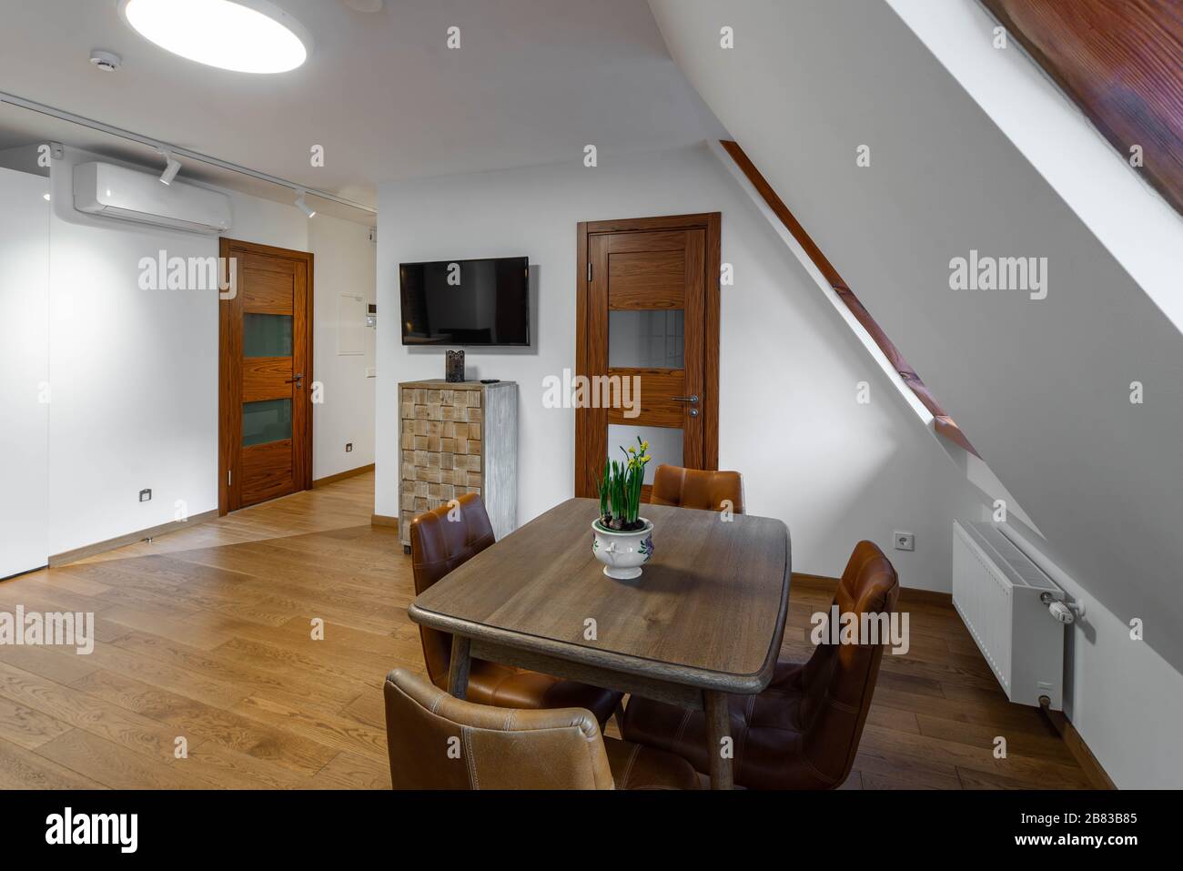 Doubleheight Living Room Of The Home With Sloping Ceiling