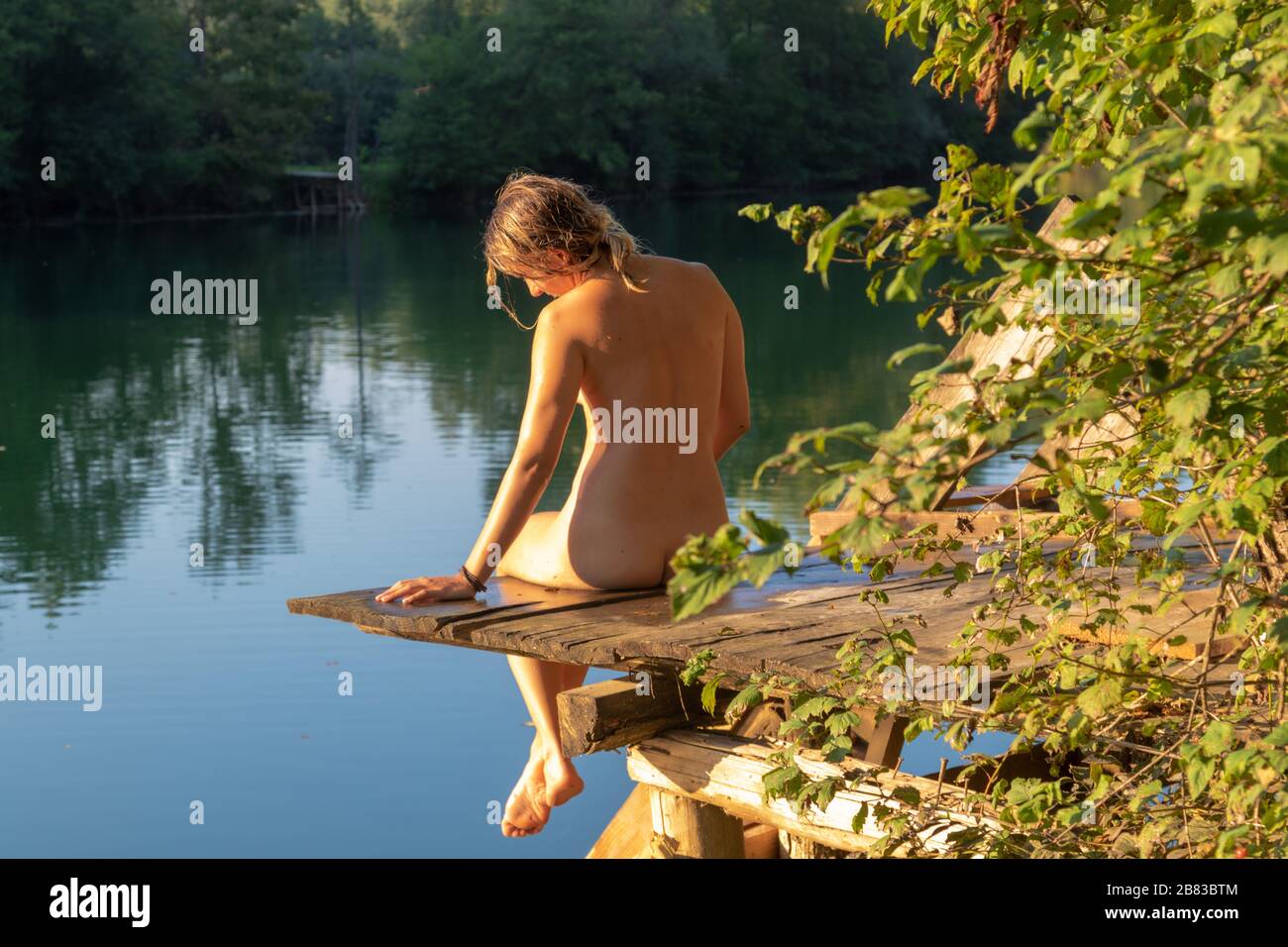 nudist gril Nudist girl takes a sunbath on the river bank Stock Photo - Alamy