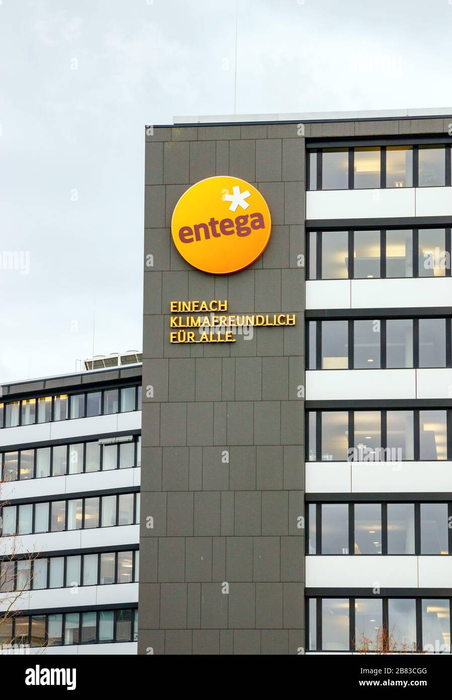 Entega logo and a text reading 'Climate Friendly Simply for All' at the facade of an office building. Darmstadt. Stock Photo