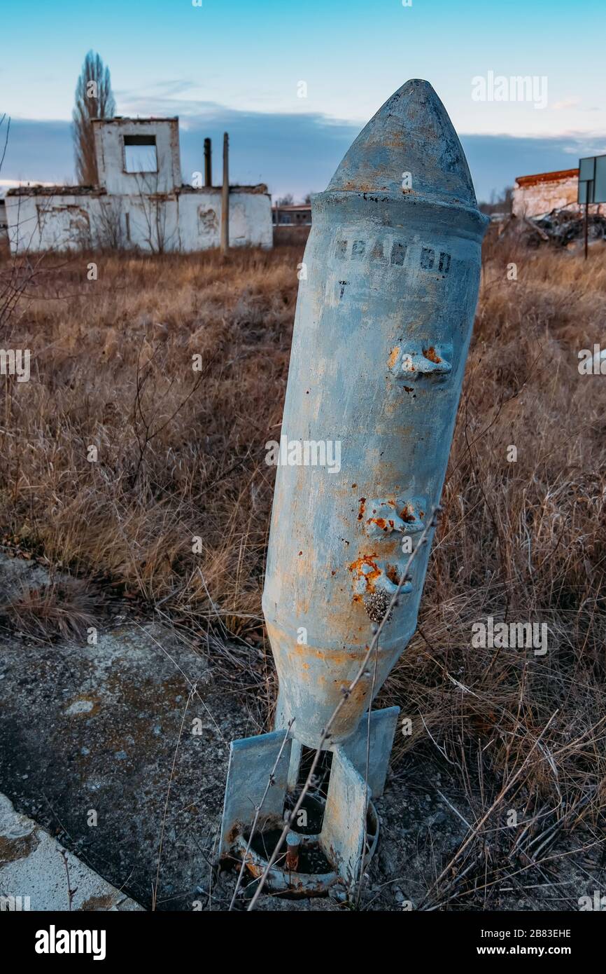 Unexploded bomb in the grass, war and peace concept Stock Photo