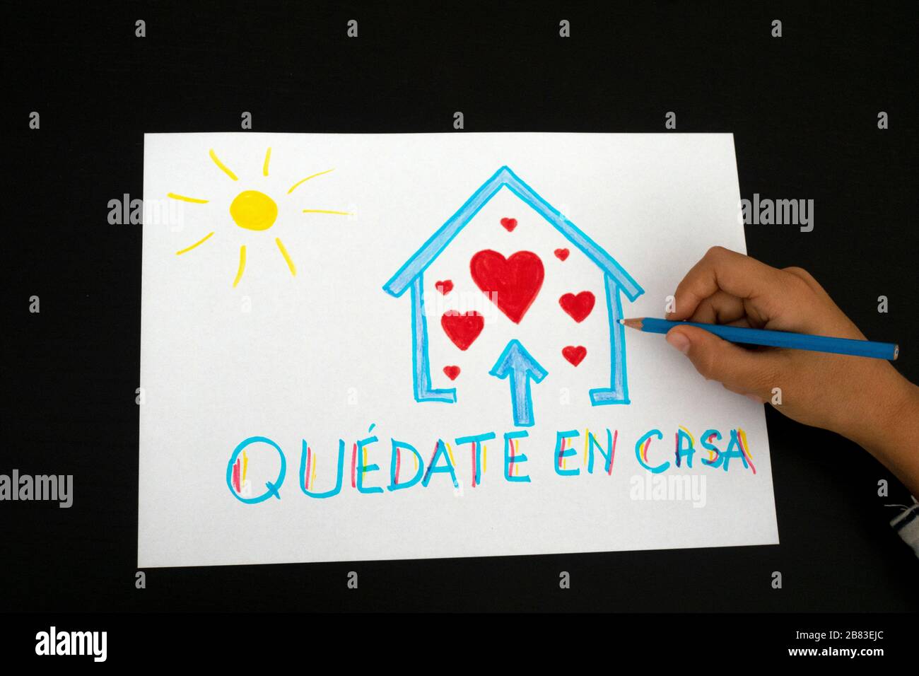 Quarantine in Spain. Kid hand draw picture with spanish words Quedate en casa - Stay at home Stock Photo