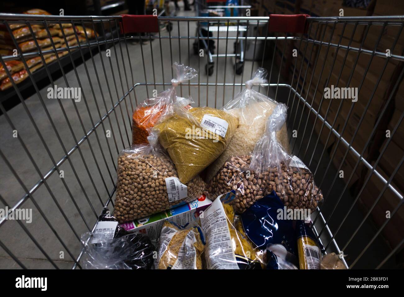 Lots of legumes are in the shopping cart including rice, olive, red lentil, chickpea, kidney bean, bulghur. Stock Photo