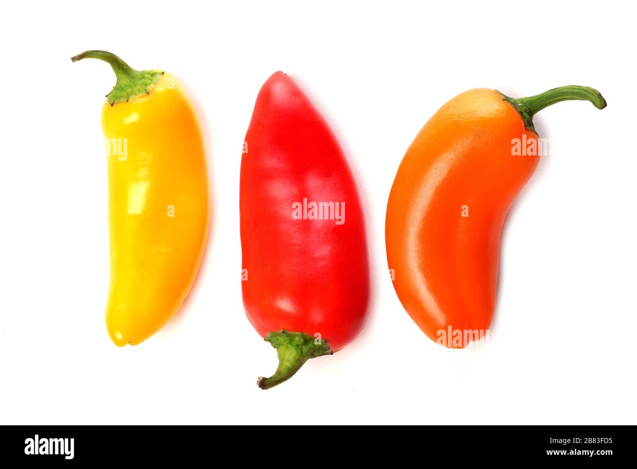 Three mini sweet peppers, yellow, red and orange isolated on a white background Stock Photo