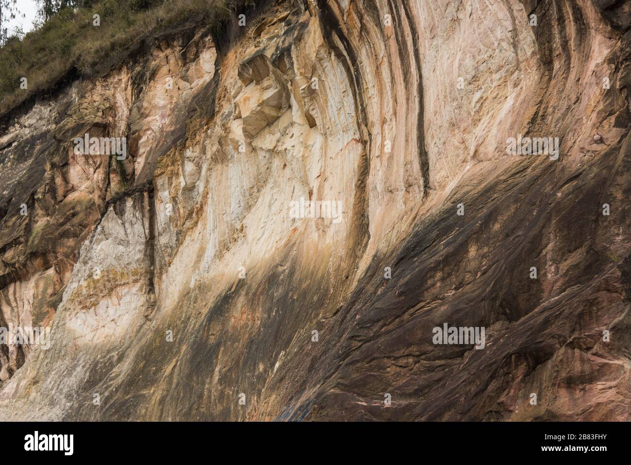 Natural background, yellowish earth cliff wall with rough texture Stock Photo