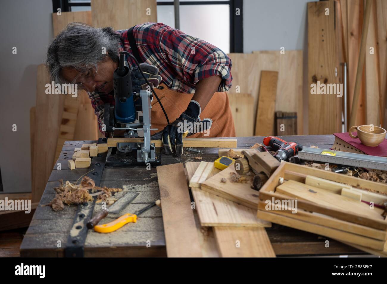 The carpenter is using the tools to work in the wooden studio Stock ...