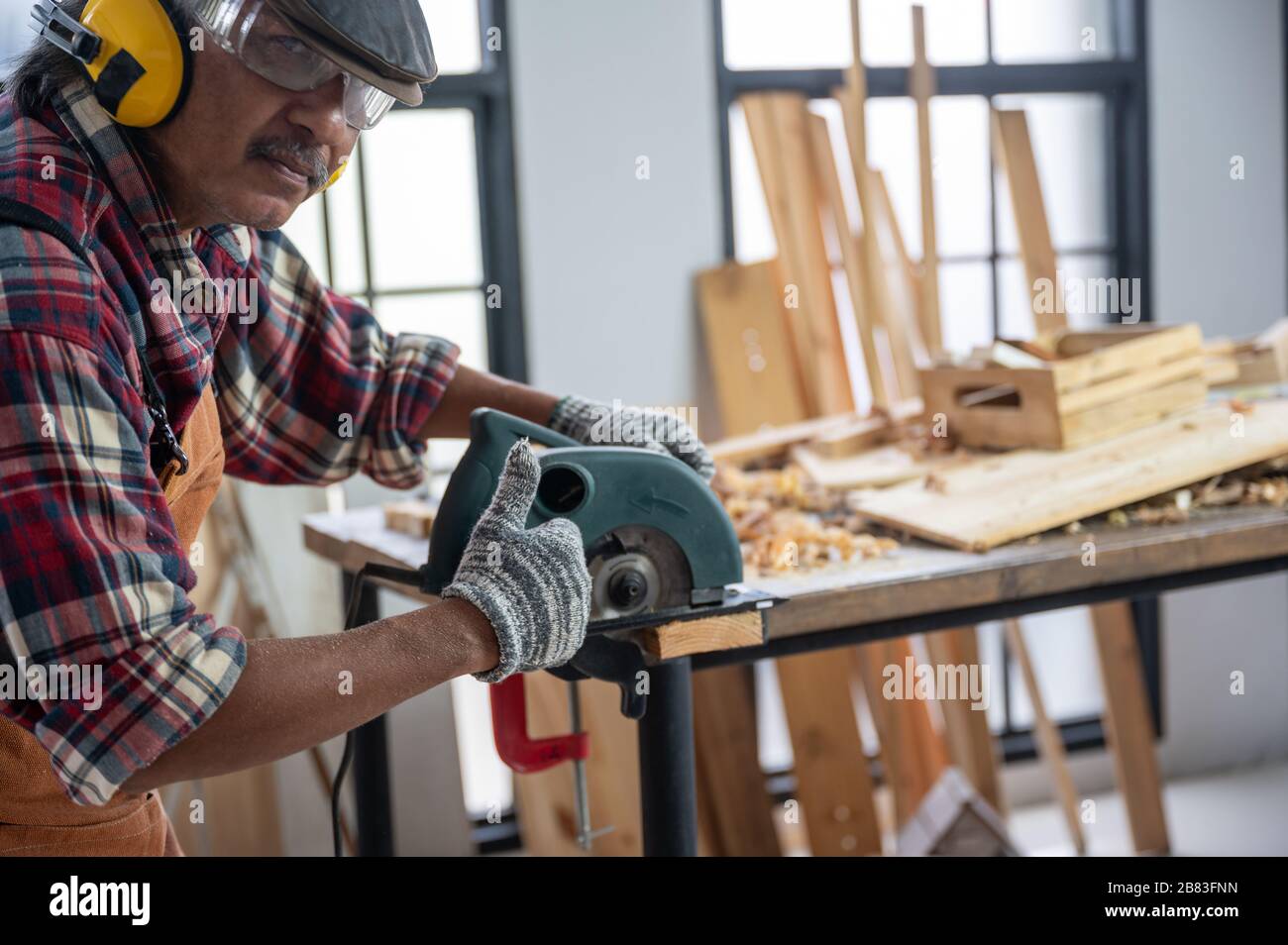 The carpenter is using the tools to work in the wooden studio Stock ...