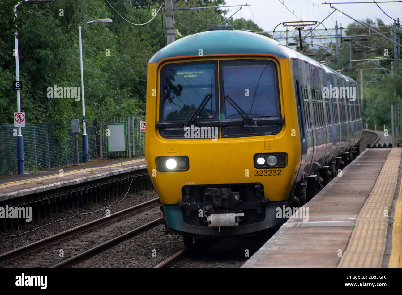 Northern Trains Class 323 electric multiple-unit, suburban train, entering railway station at Bramhall, Stockport, Cheshire, near Manchester, England Stock Photo