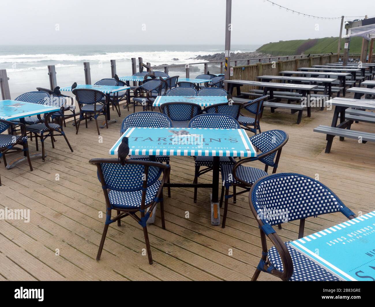 UK Weather, 19th March 2020. UK Fistral beach Newquay Cornwall. bars cafes and amusement arcades left deserted as public heed advice to stay away. Cre Stock Photo