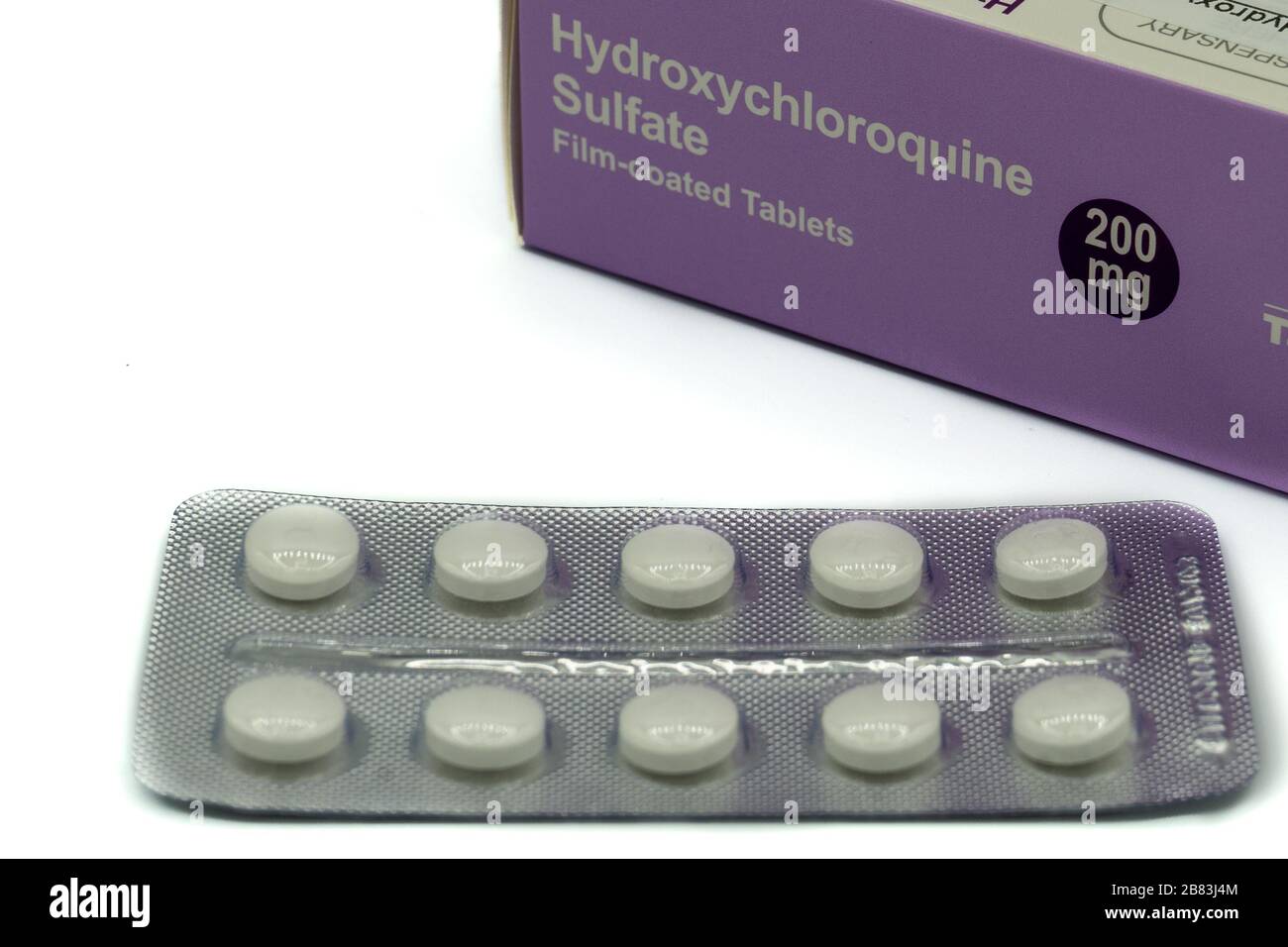 A box of Hydroxychloroquine tablets with the tablets in a packet in front also known as chloroquine or plaquenil Stock Photo