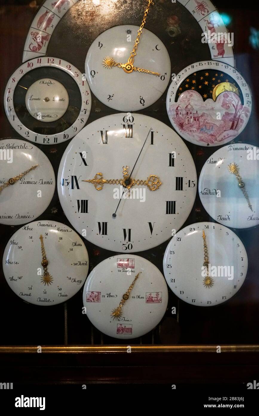 Antique clock with multiple faces to show day and night, time, date