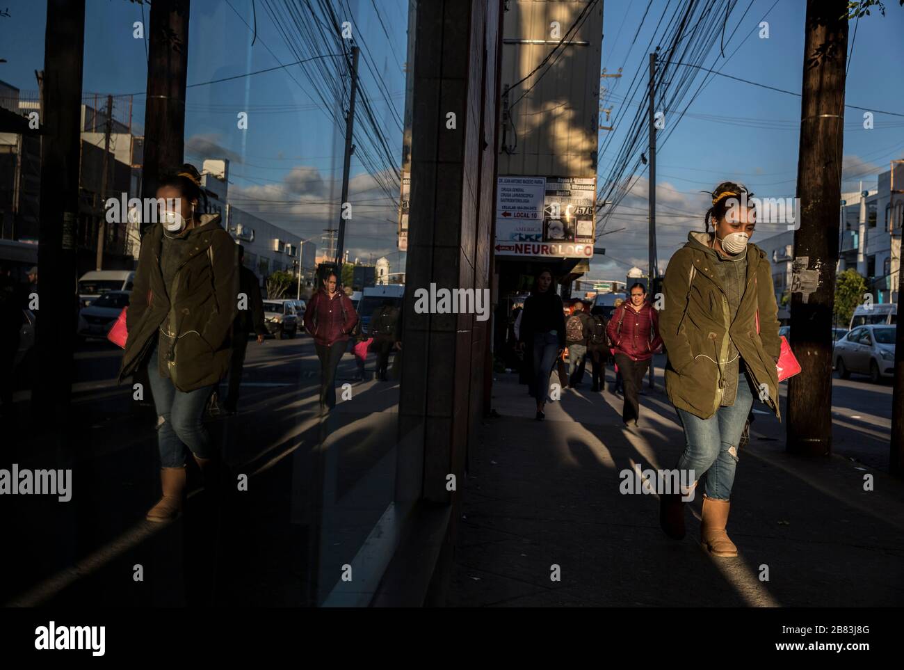 Tijuana, Mexico. 18th Mar, 2020. A woman walks through the city wearing a protective mask. Despite the threat of possible restrictions on entry regulations by the USA, people are allowed to cross the border without special measures. For fear of the corona virus, Mexicans and also US citizens who cannot find certain products in San Diego (USA) stand in long queues in front of wholesalers. Mexico has so far reported 118 Covid-19 infected people. USA has almost 10 000 confirmed cases. Credit: Omar Martínez/dpa/Alamy Live News Stock Photo