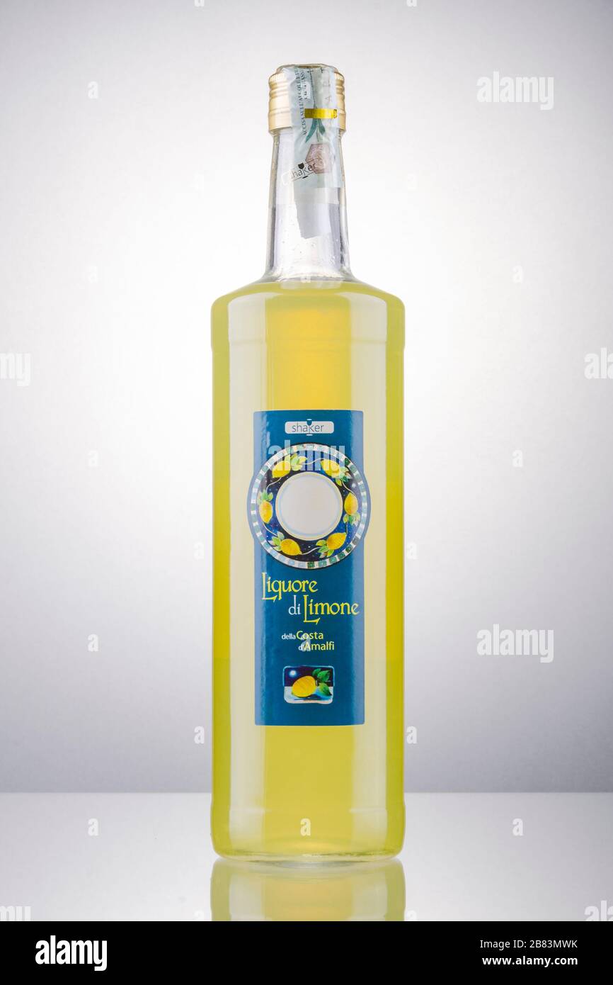 Bottle of Shaker lemon liqueur isolated on gradient background. This