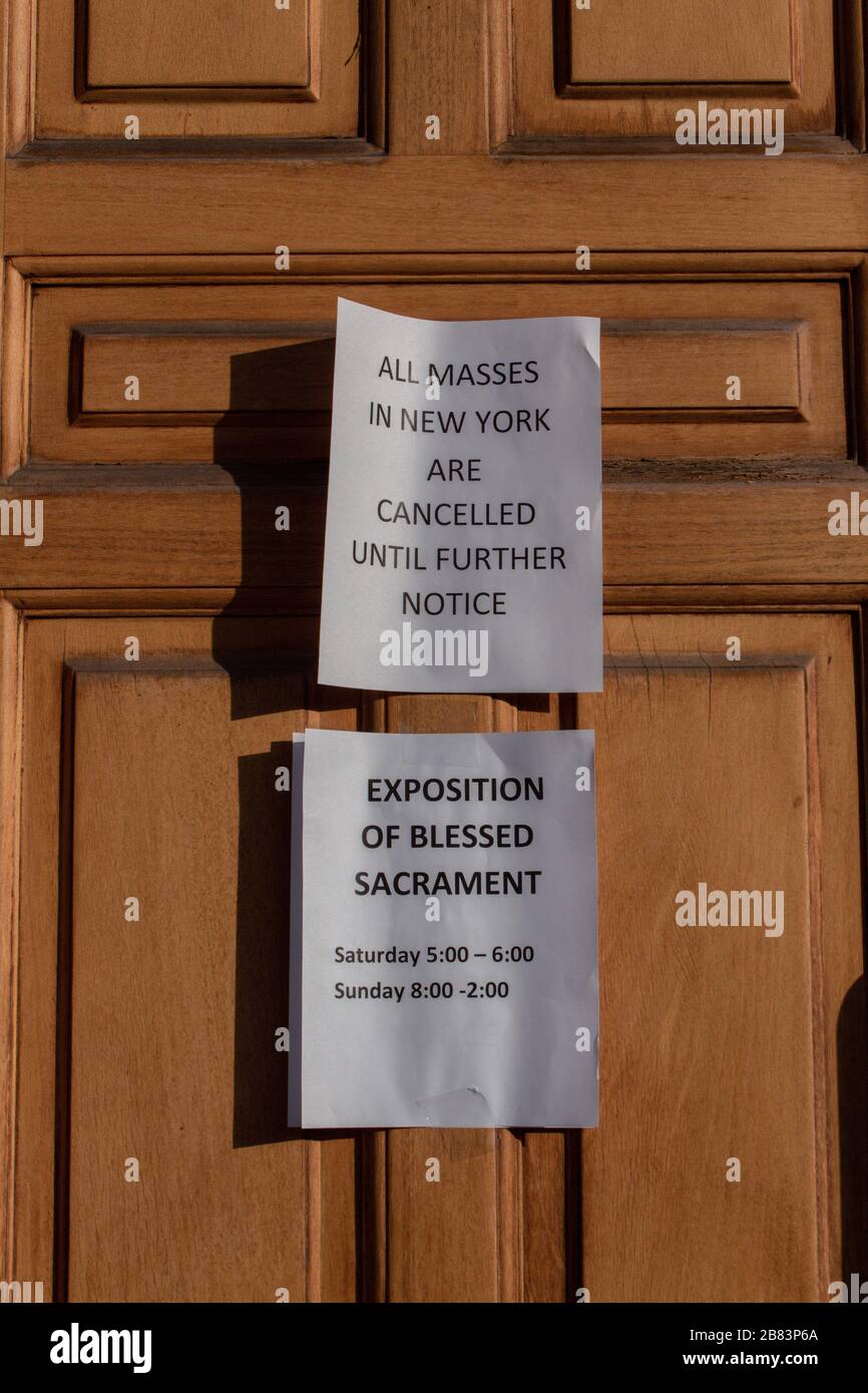 sign on the Church of the Good Shepherd in Inwood, New York stating all masses have been cancelled due to the coronavirus or covid-19 pandemic Stock Photo