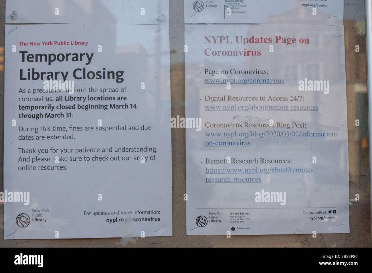signs at the Inwood branch of the New York Public LIbrary stating it is closed due to the coronavirus covid-19 pandemic and where to get information Stock Photo