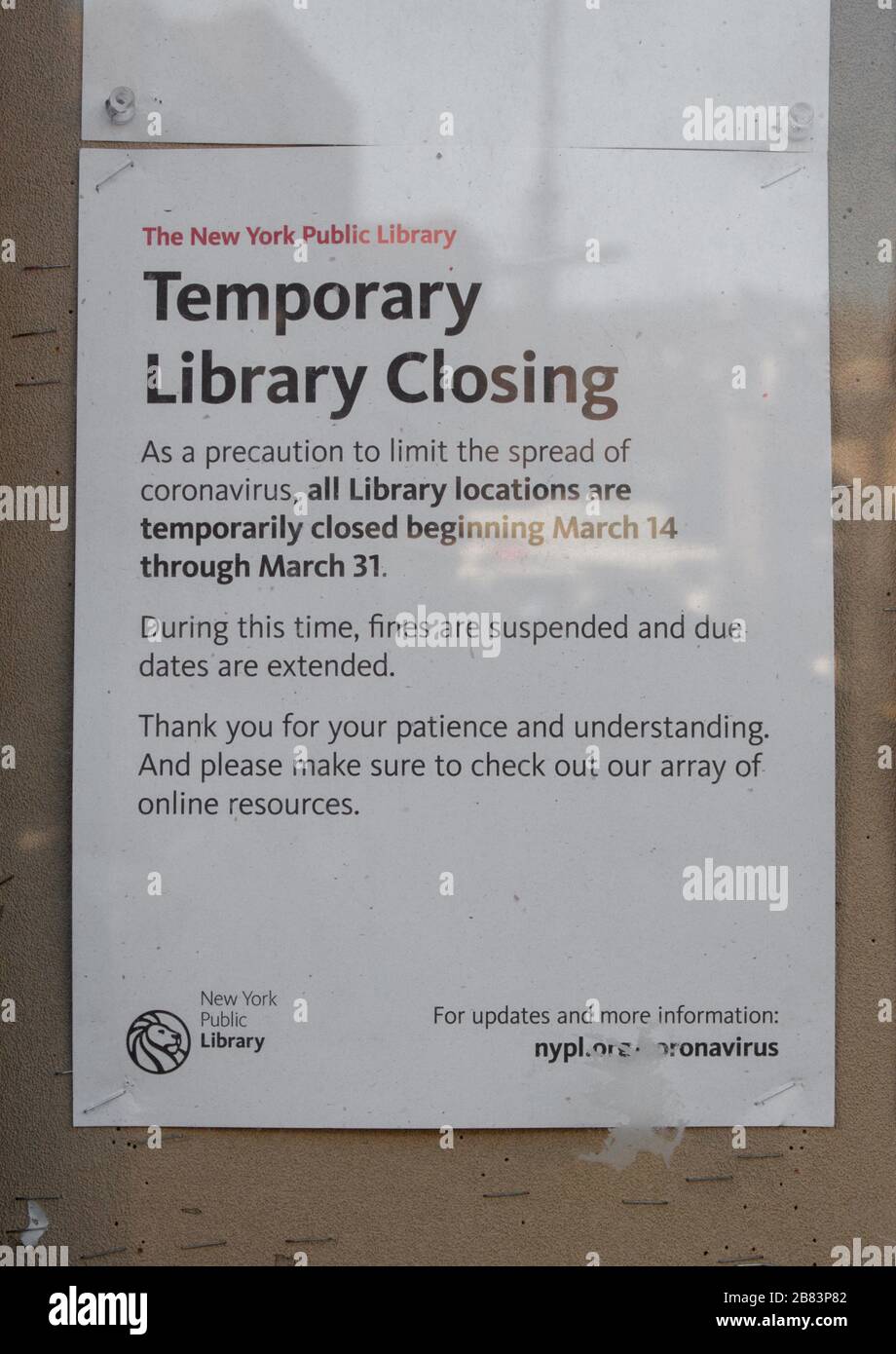 sign on the Inwood branch of the New York Public Library stating it is closed due to the coronavirus or covid-19 pandemic Stock Photo