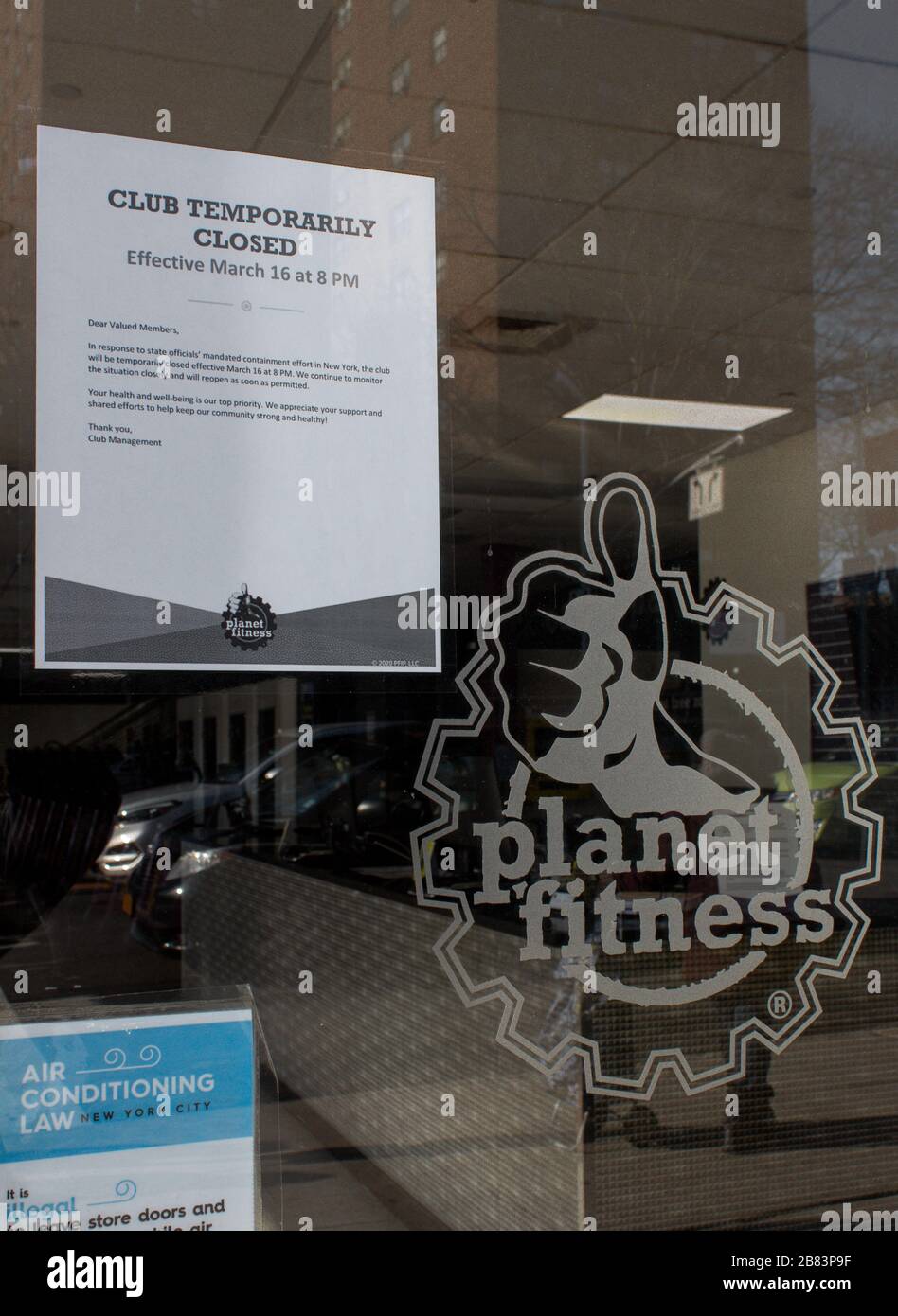 sign on the door of a Planet Fitness gym location in the Bronx stating it is closed due to the coronavirus or covid-19 pandemic Stock Photo