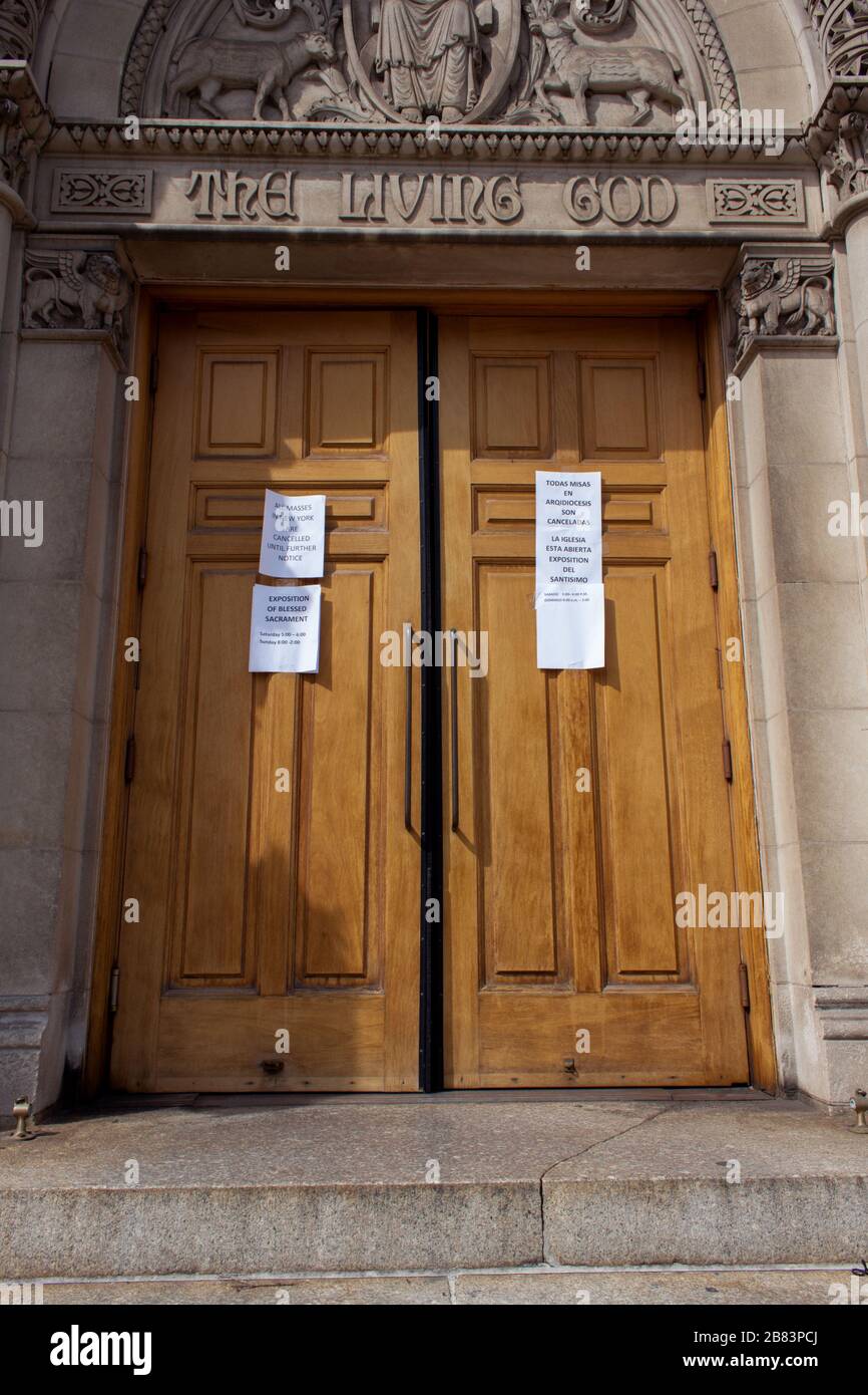 entrance to the Church of the Good Shepherd in Inwood, New York with signs stating masses are cancelled due to the coronavirus covid-19 pandemic Stock Photo