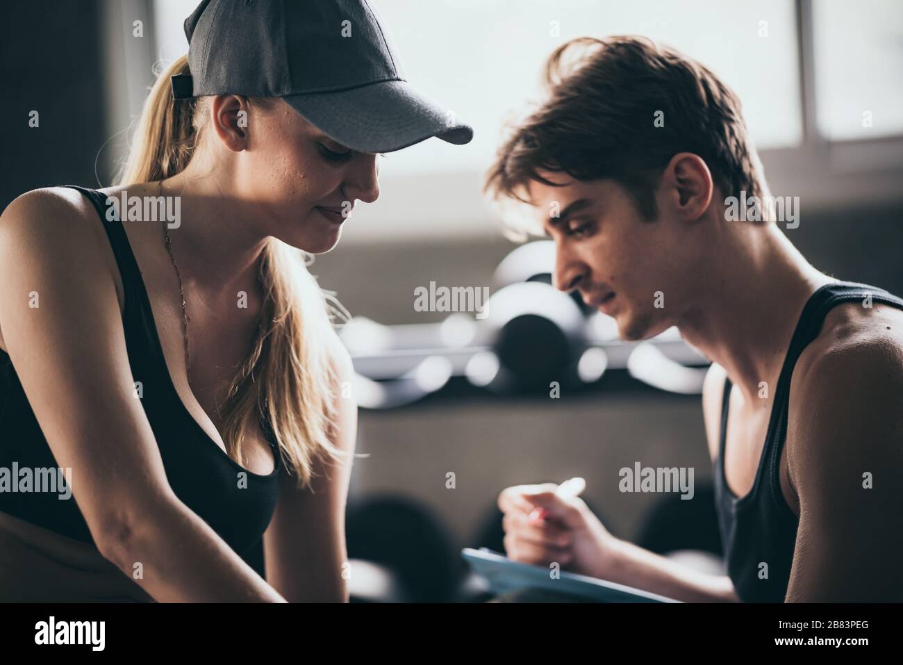 Fitness couple - woman and man in sport gym Stock Photo