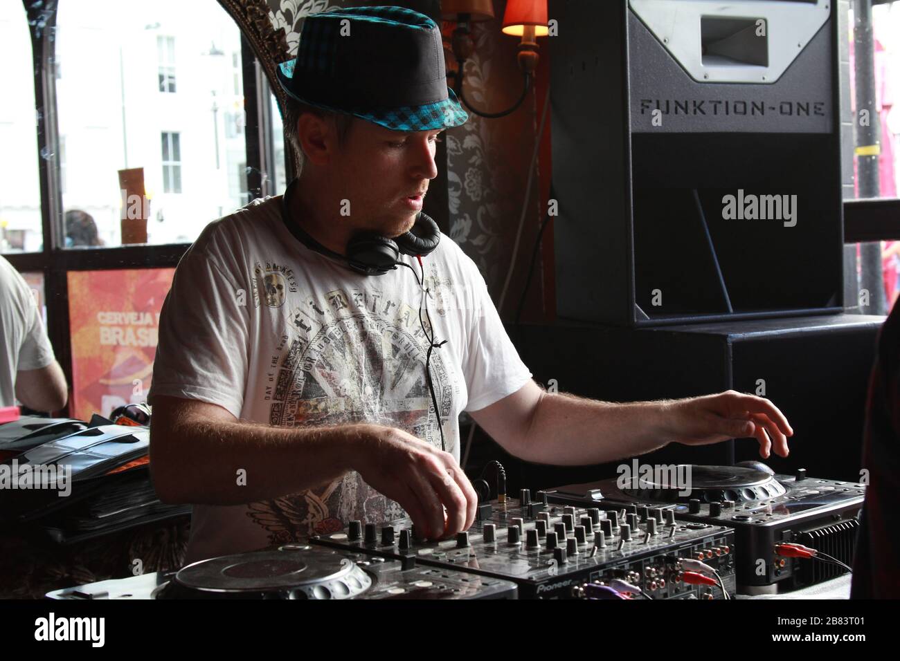 DJ playing music on mixer sound system at Notting Hill carnival in