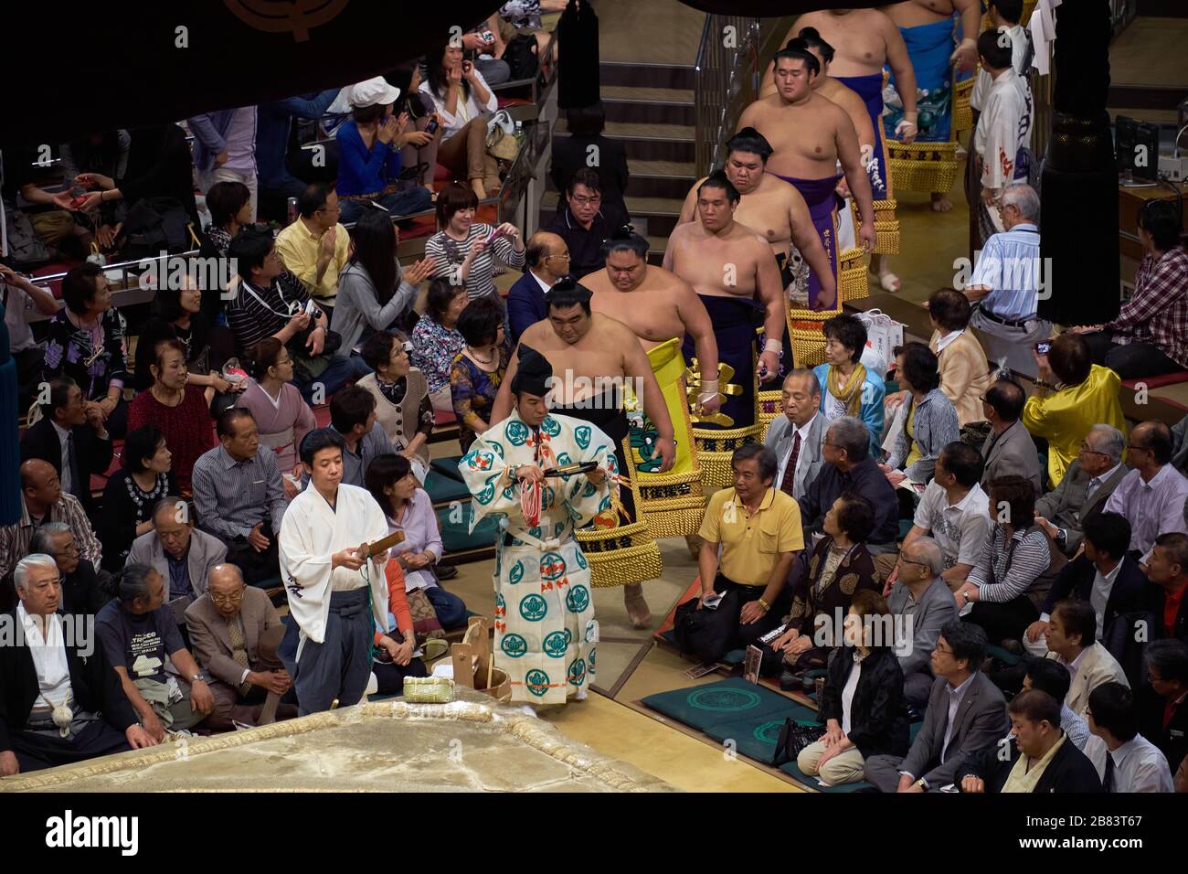 Sumo wrestlers entering sumo wrestling ring for closing ceremony