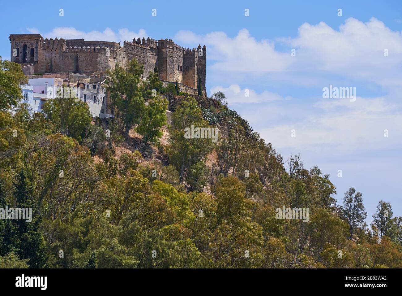 The castle and chuch tower of historic white village Arcos de la Frontera, Province of Cadiz, Andalusia (Andalucia) on top of the hill. Spain. Europe Stock Photo