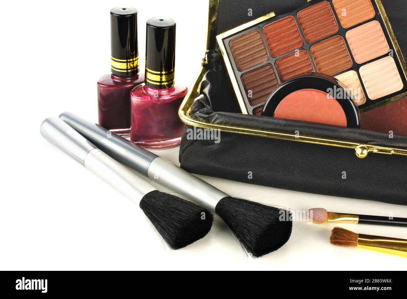 Makeup bag close up with assorted cosmetics on a white background Stock Photo