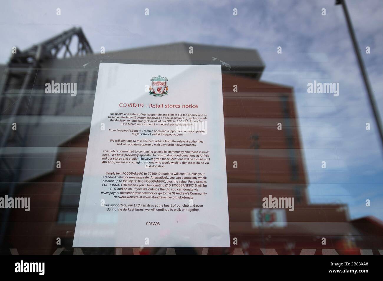 A notice in the window of the Liverpool Football Club shop at Anfield telling customers that it has temporarily shut due to Covid-19 Coronavirus Stock Photo