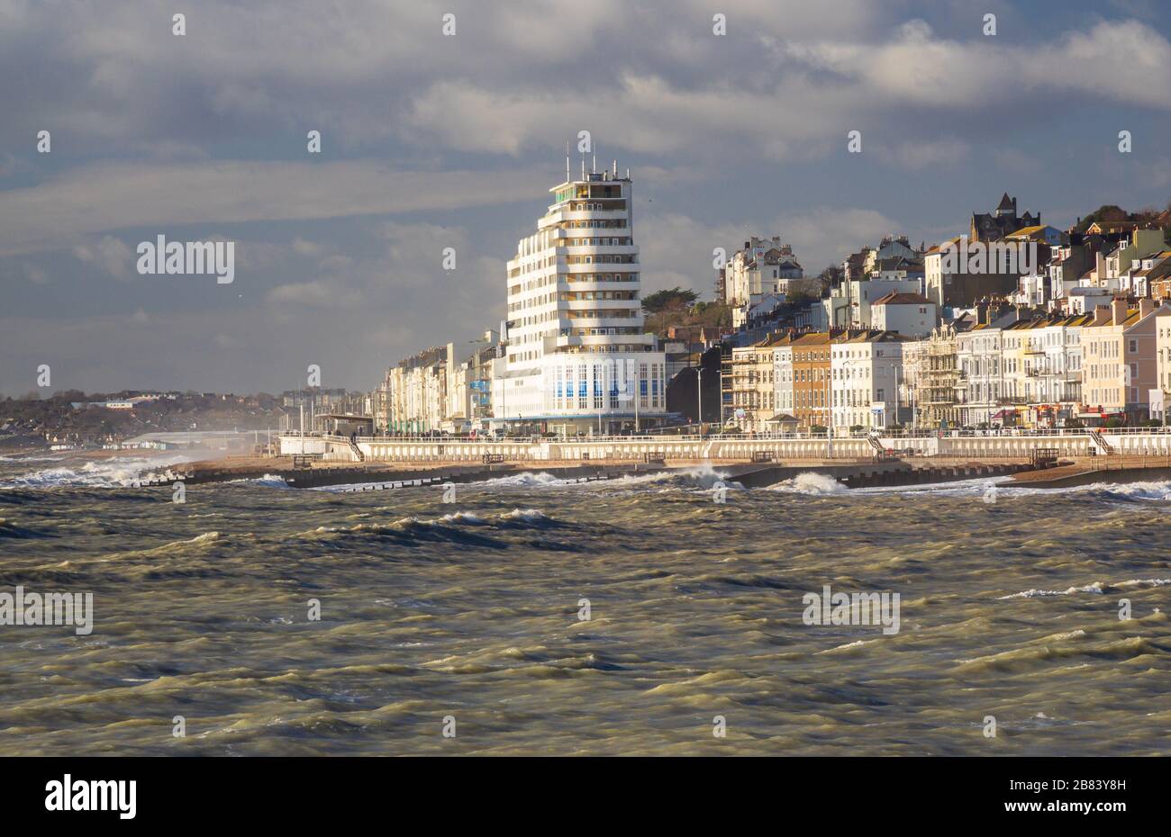 Hastings sea front in winter sun with high waves Stock Photo