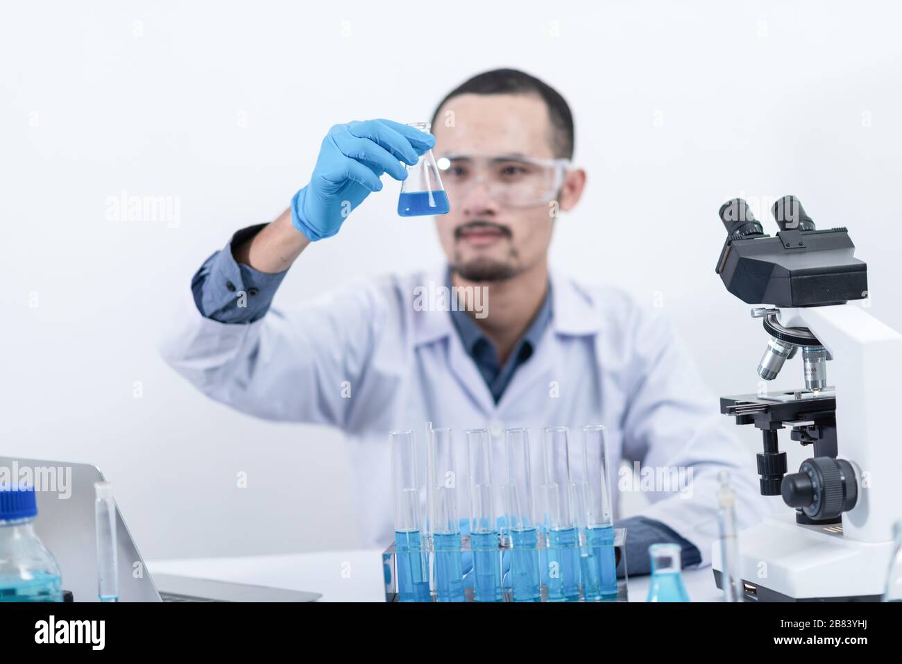 scientist with equipment and science experiments, laboratory glassware ...