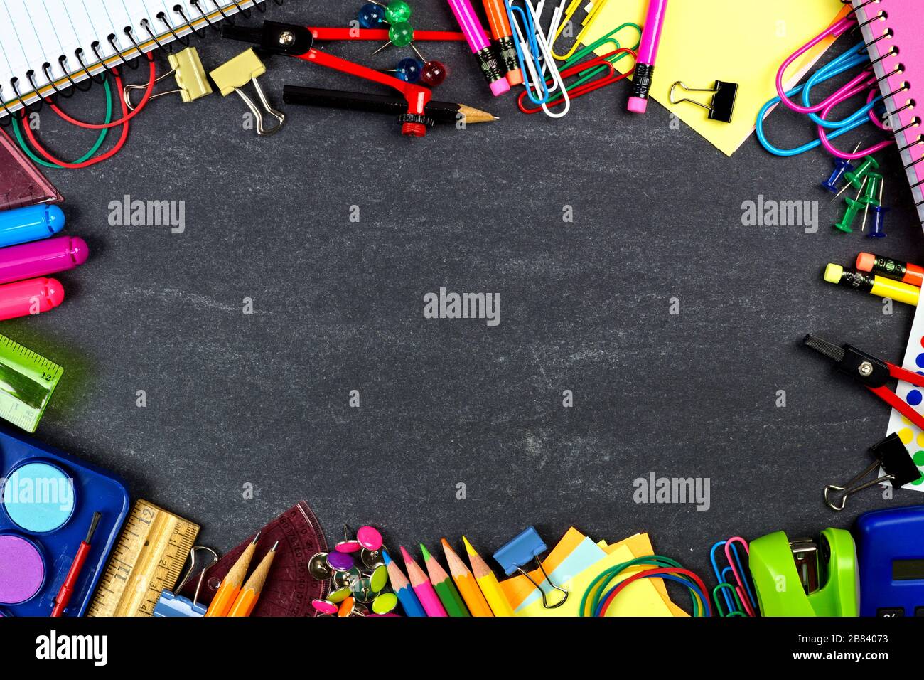 School supplies frame on a chalkboard background Stock Photo