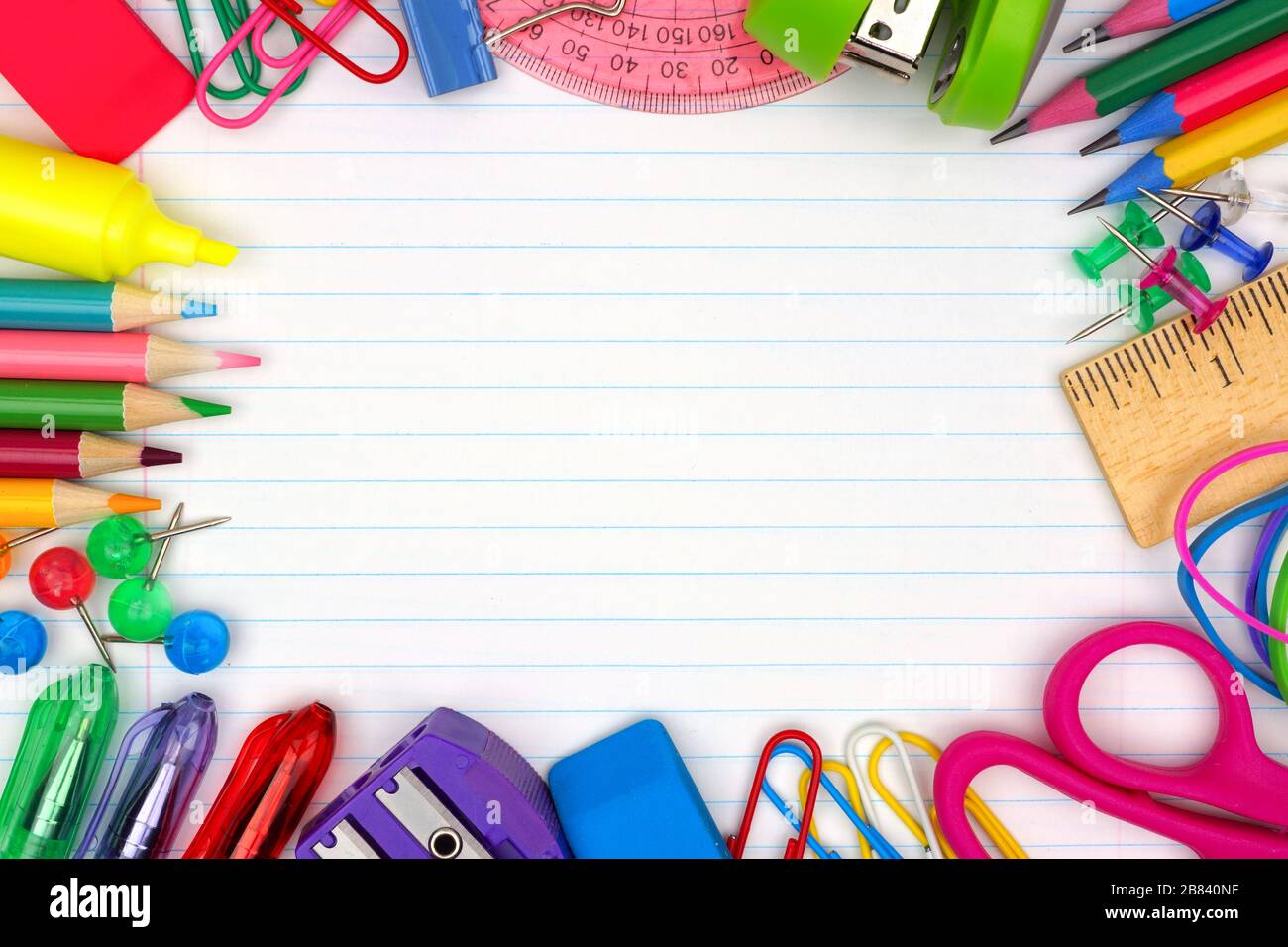 Colorful school supplies frame over a lined paper background Stock Photo