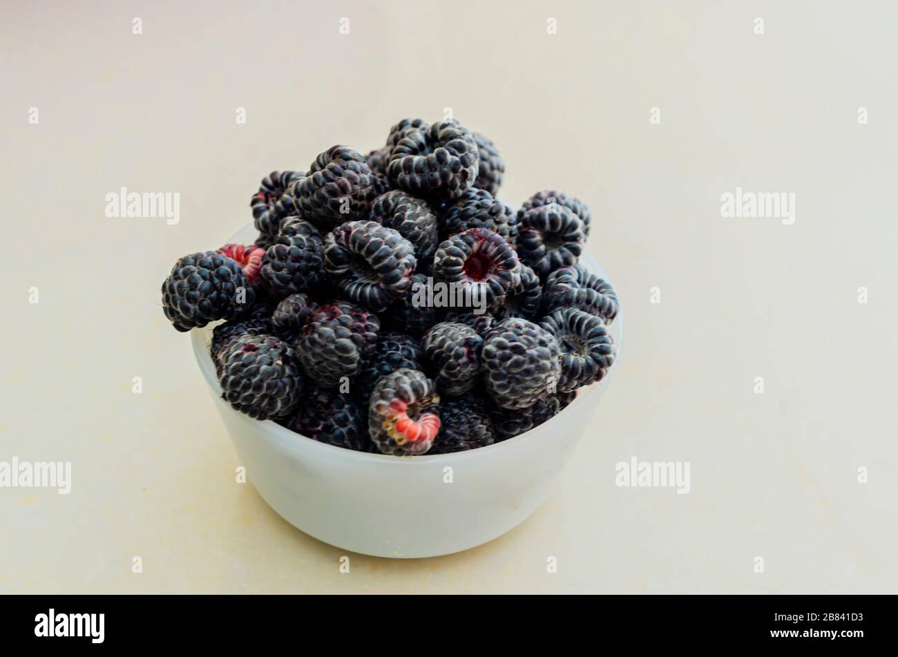 Black Raspberries In Small Dish Stock Photo - Alamy