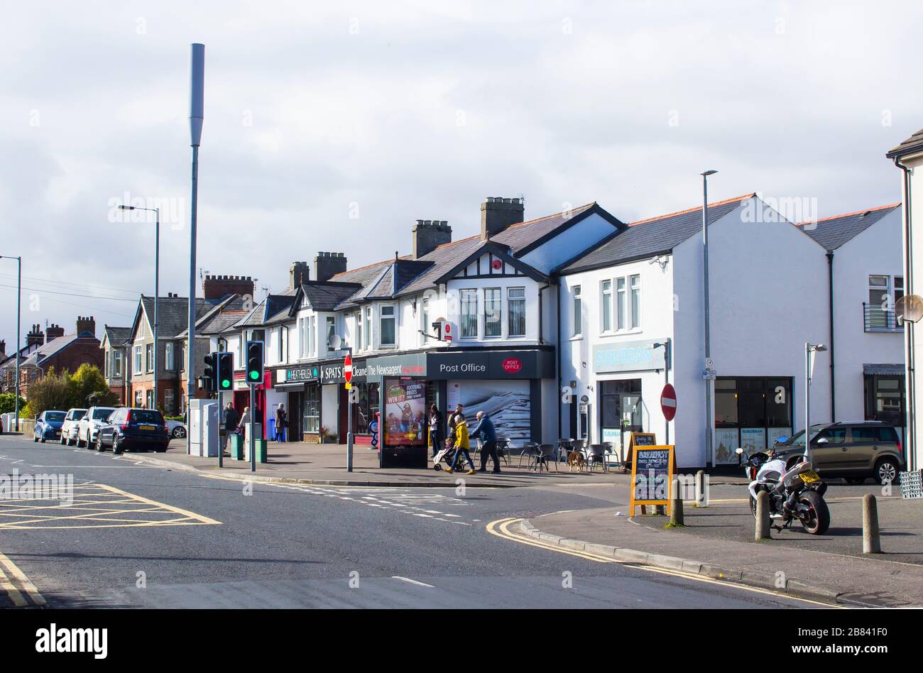 27 February 2020 Parked cars and pedestrians in the Ballyholme Village area on the Groomsport Road Bangor County Down Northern Ireland on a bright aft Stock Photo