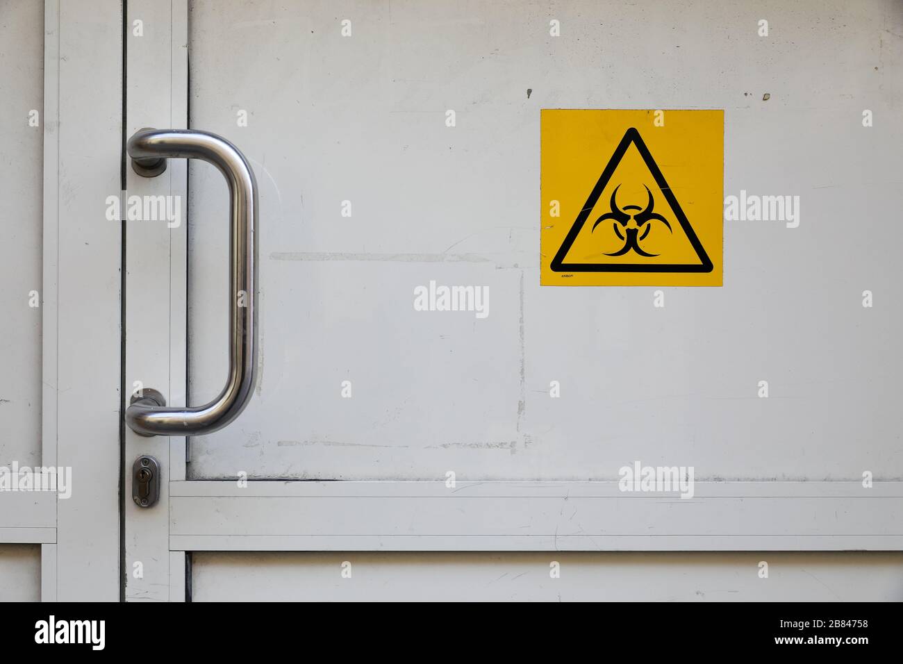 Cracow, Lesser Poland, Poland. 17th Mar, 2020. A bio-hazard sign on the door leading to the construction site in an old building during the corona virus pandemic.Polish Government has introduced a state of epidemiological emergency and closed borders. Most public places like schools, universities, restaurants, etc. have been closed to prevent the spread of coronavirus. Credit: Filip Radwanski/SOPA Images/ZUMA Wire/Alamy Live News Stock Photo