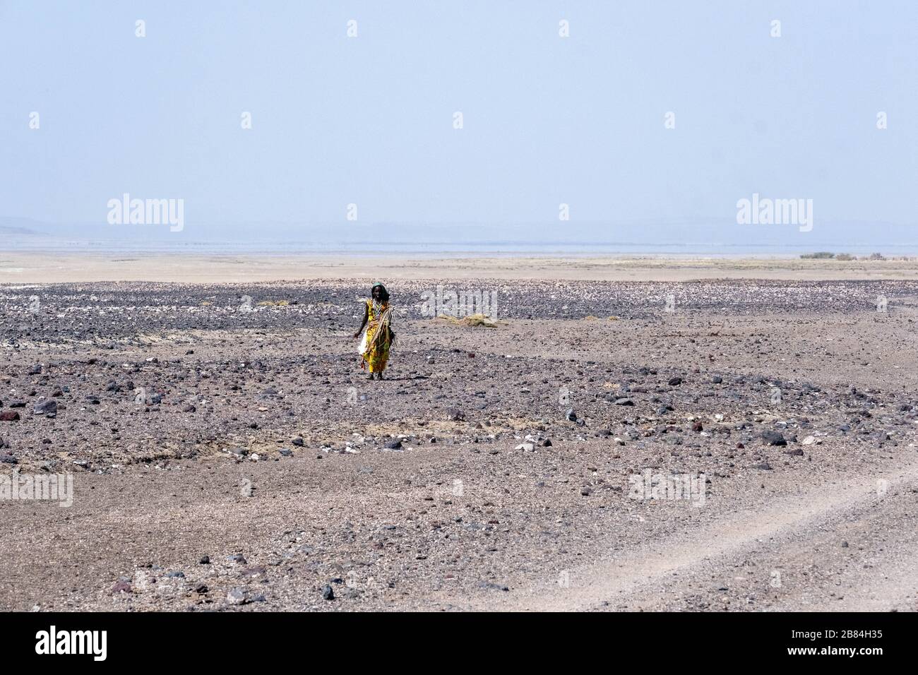 Africa, Djibouti, Lake Abbe. A A woman walks in the desert on the way to Lake Abbe Stock Photo