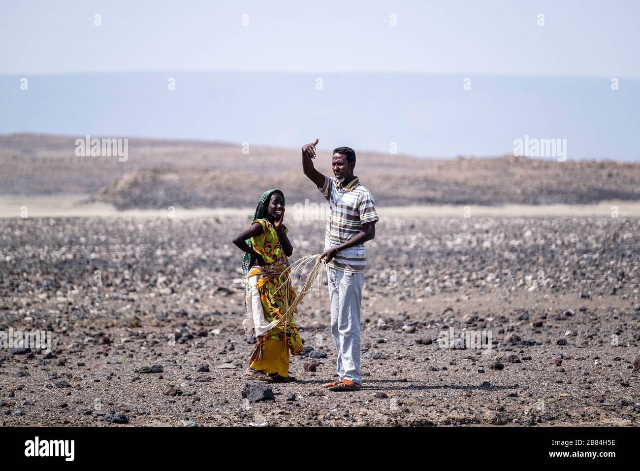 Africa, Djibouti, Lake Abbe. A A woman talks with a man in the desert on the way to Lake Abbe Stock Photo