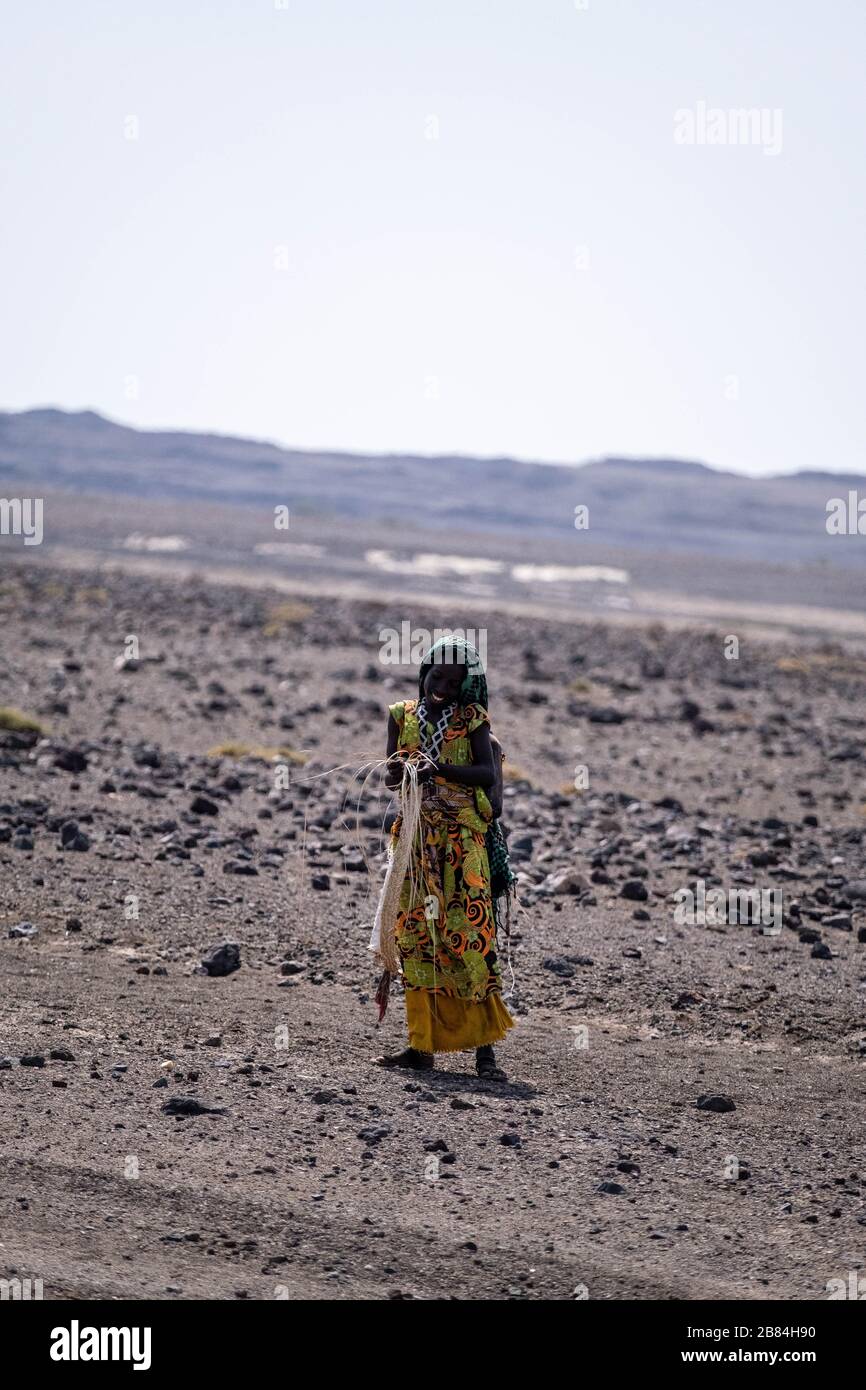 Africa, Djibouti, Lake Abbe. A A woman walks in the desert on the way to Lake Abbe Stock Photo