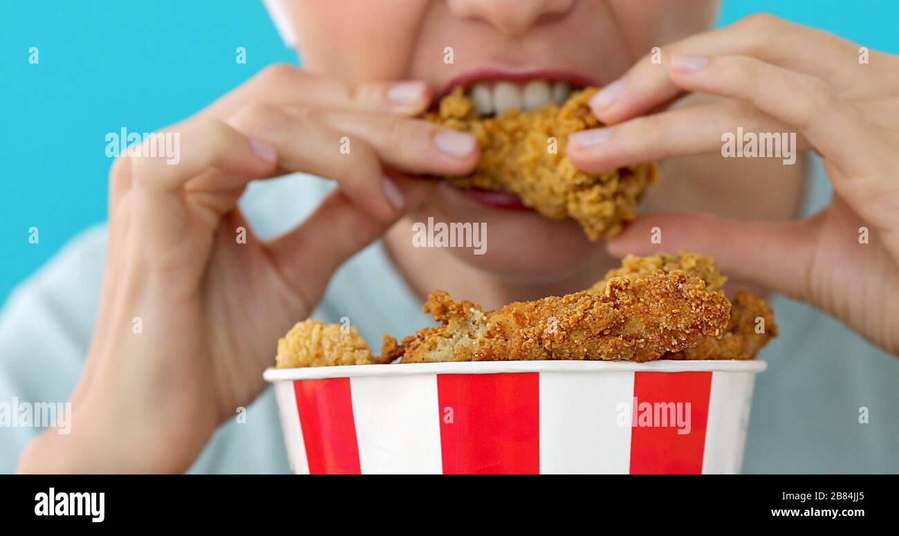 Girl eating chicken wings Stock Photo Alamy