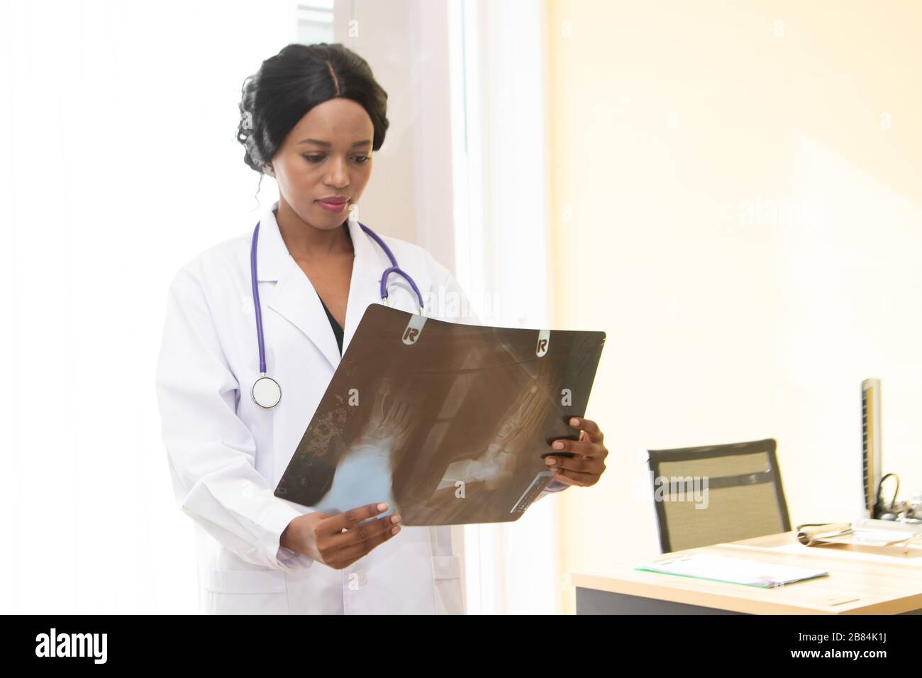 The African doctor looking x-ray film in the hospital Stock Photo - Alamy