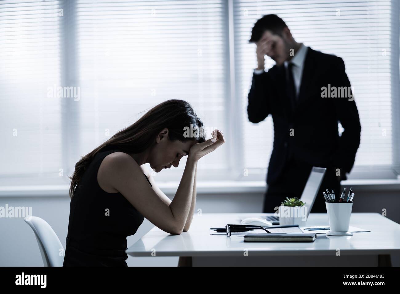 Team Of Unhappy Businesspeople Sitting In Business Meeting Stock Photo