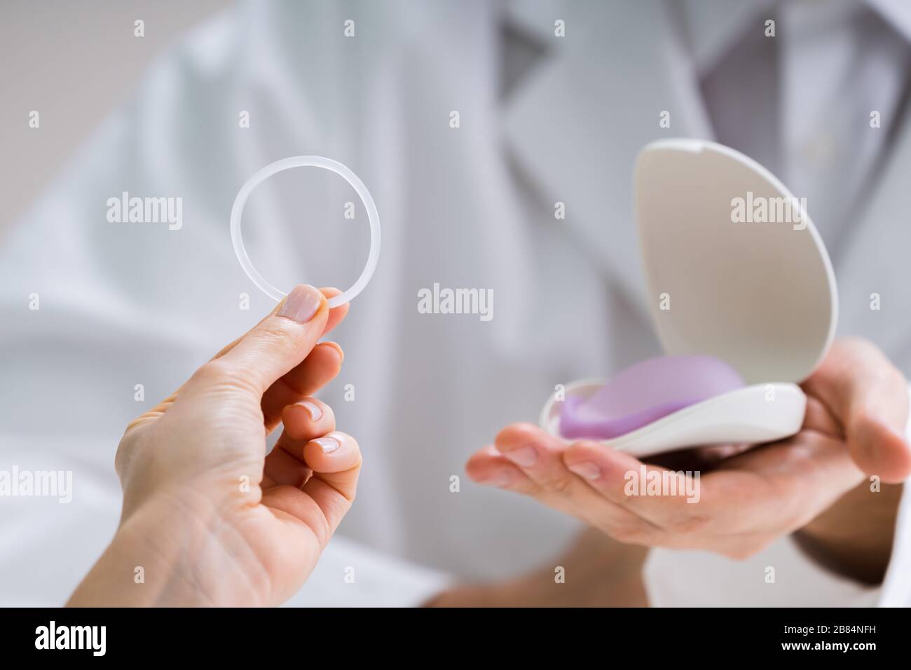 Gynecologist Showing Contraception Ring To Woman And Explaining