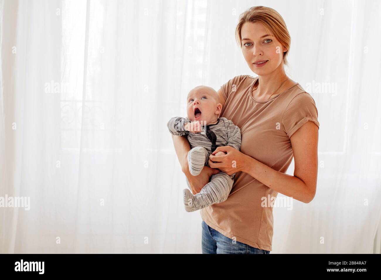 Beautiful female with cute baby Stock Photo